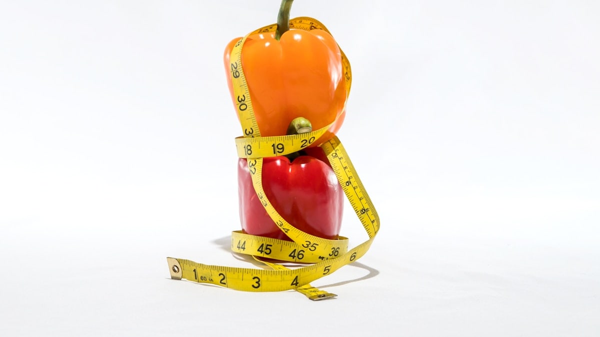 a measuring tape wrapped around a bell pepper
